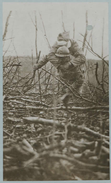 Photograph of a Red Cross Worker Carrying a Wounded Soldier. Courtesy of Imperial War Museums.